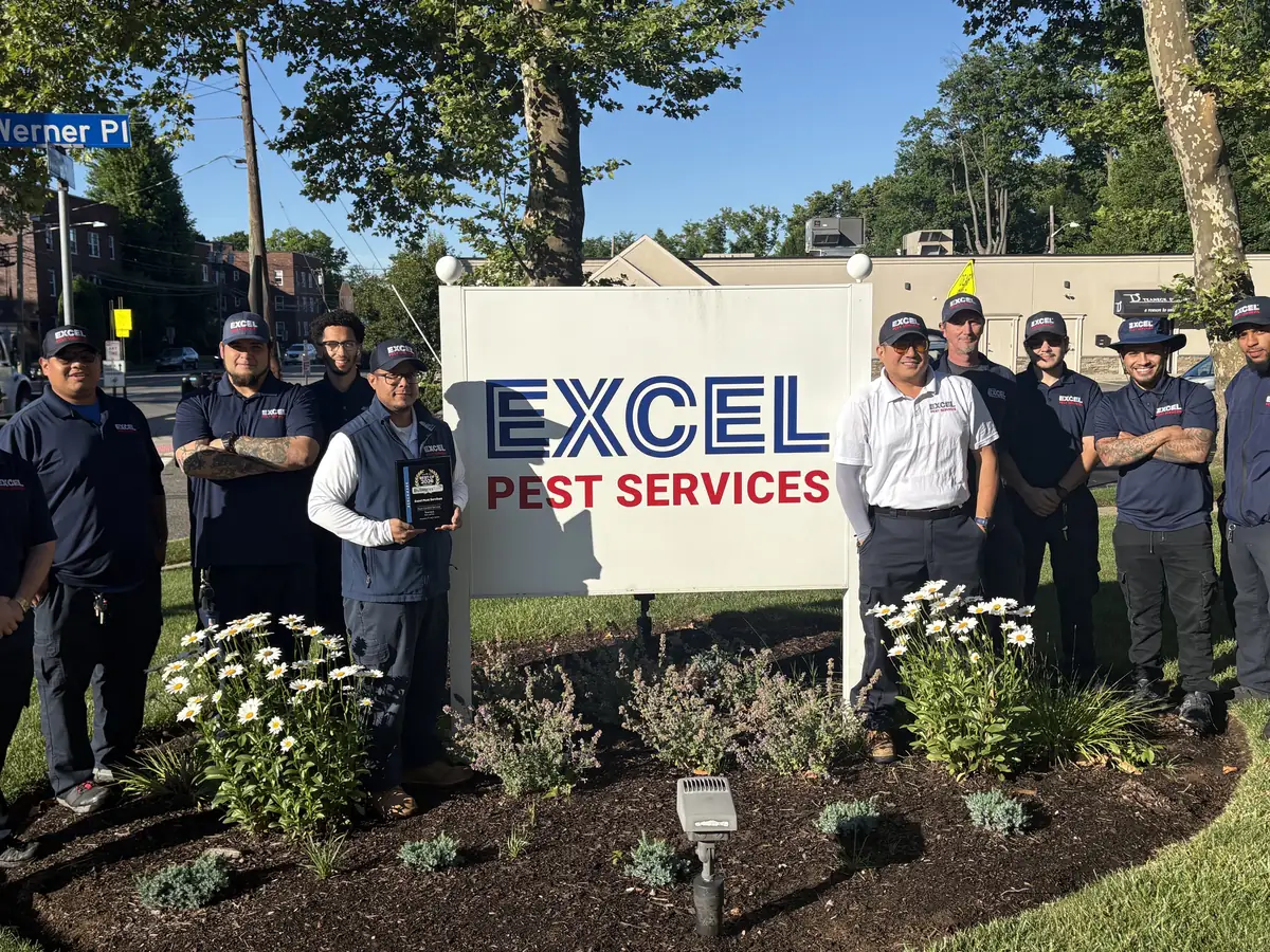 Teaneck pest control team holding the Best of 2026 pest control company in Teaneck plaque.